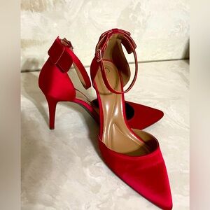 Elegant, red satin dress shoes with bow detail.